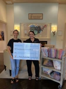 Taylor and Amy Hold Large Donation Check for $6,500