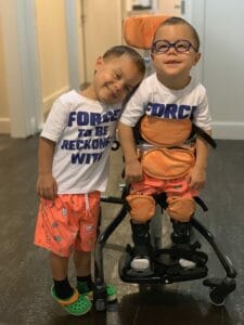 Twin brothers hugging in the hallway of Ronald McDonald House